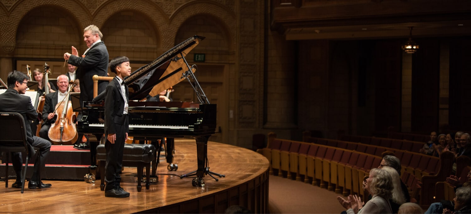 orchestra performing on stage during concerto round